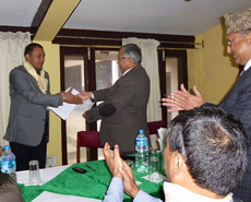 Khageshwaar Sharma and Prof Dhakal exchange the renewed MOU documents