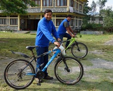 Narayan & Subash setting off by bicycle on a street dog treatment call