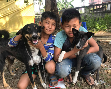 Two young owners with their dogs in Dharan