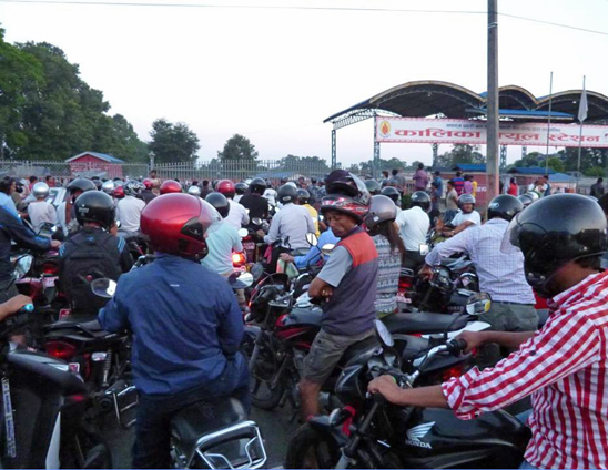 Motorcyclists nearing the front of a fuel queue in Pokhara