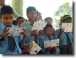 Leaflets giving rabies-avoidance information are handed out to local schoolchildren