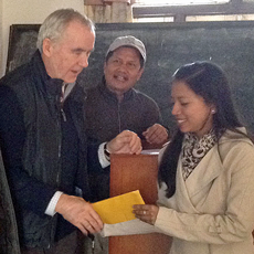 Vet student, Ms Sanam Maharjan, being presented with her HART bursary by visiting vet lecturer, Dr Russell Lyon