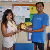 Tracy Yip shown here receiving a token of appreciation from Narayan Dhakal